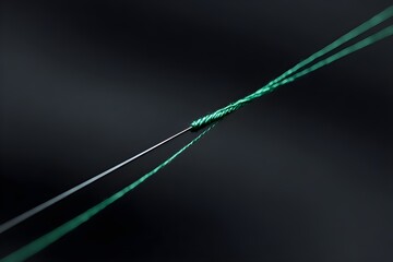 Fototapeta premium Single Needle Threading Through Emerald Green Thread Macro Shot Sewing Craft Close-up Detail Photography