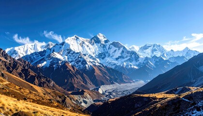 Majestic Snow Capped Mountain Range Under A Clear Blue Sky With Wispy Clouds And A Rugged Valley Below