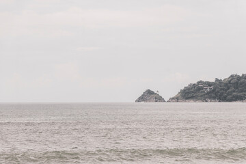 Patong Beach Phuket with turquoise blue water and mountains Thailand.