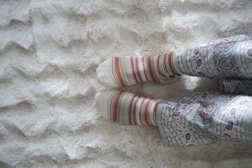 Cozy socks on a soft rug in a serene room setting