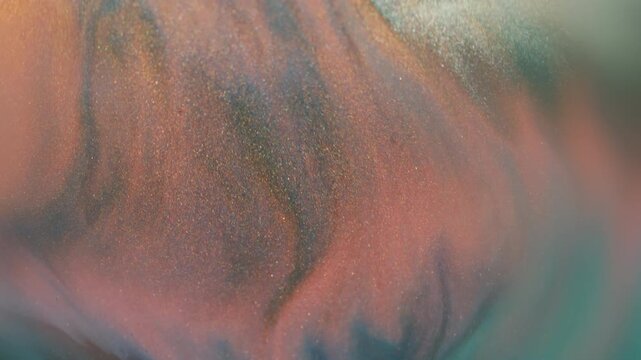 Blur paint splatter. Marble texture. Defocused orange purple blue color glitter water shiny particles spreading on abstract background.
