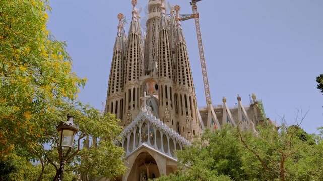 Cinematic 4K close-ups of Gaud&iacute;'s masterpiece, Sagrada Familia. Sunlight streams through the stained-glass windows, painting the forest-like interior with a rainbow of vibrant colors.