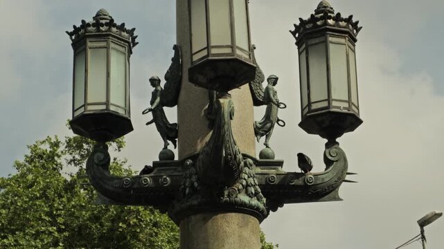 Cinematic 4K footage of Pla&ccedil;a de Catalunya, the bustling central square and vibrant heart of Barcelona. The video captures the constant flow of people, the iconic fountains, unique modern sculptures.