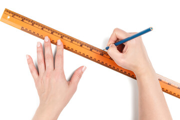 Female hands using orange ruler and blue pencil to draw straight line. Creative design or education...