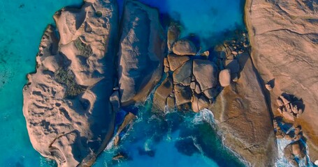 Waves paint the rocks with white foam as the crash onto the rocy outcrop at Twilight Beach, Esperance, Western Australia