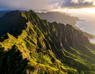 Aerial view of a lush, jagged mountain range meeting the vast ocean