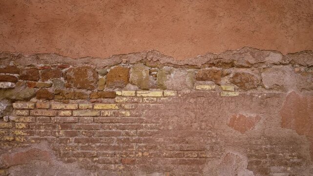 Old brick and plaster wall texture in warm terracotta and yellow tones, sharp detail for facade building; background copyspace template virtual.