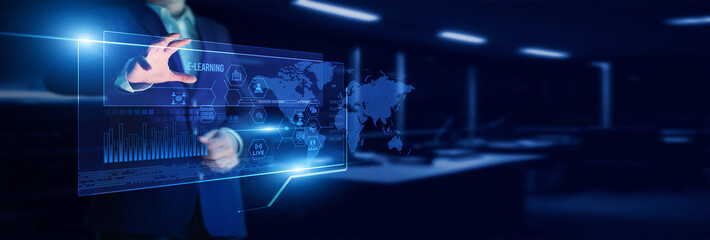 Instructor pointing to the e-learning platform with its analysis of student progress, interactive modules, engagement metrics, course outcomes, and digital education effectiveness.