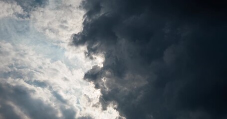 Timelapse of sun rays passing through thick dark clouds - Powered by Adobe