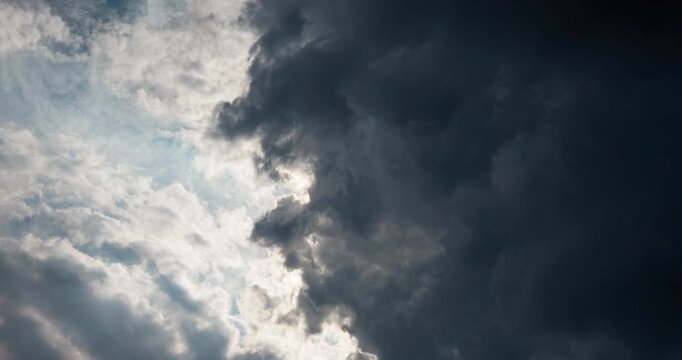 Timelapse of sun rays passing through thick dark clouds