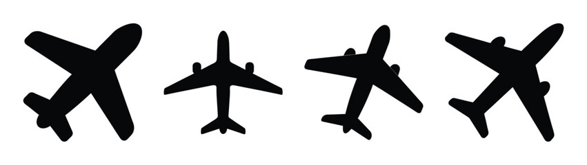 Obraz premium Set of four black airplane silhouettes with slightly textured appearances displaying different orientations and angles