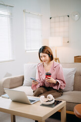 young asian woman working at home with laptop, freelancing concept