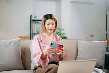 young asian woman working at home with laptop, freelancing concept