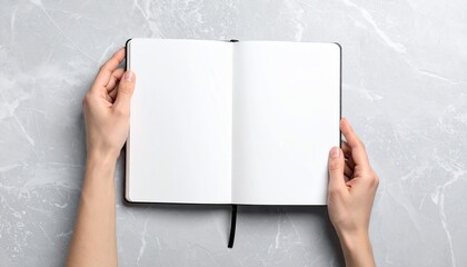 Hands Holding Open Blank Notebook on Marble with Ready for Text or Design.