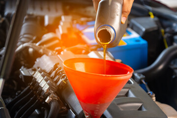 Refueling and pouring oil quality into the engine motor car Transmission and Maintenance Gear...