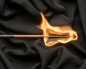 Dynamic flaming arrow launching forward with intense fire against dark textured background symbolizing power and progress