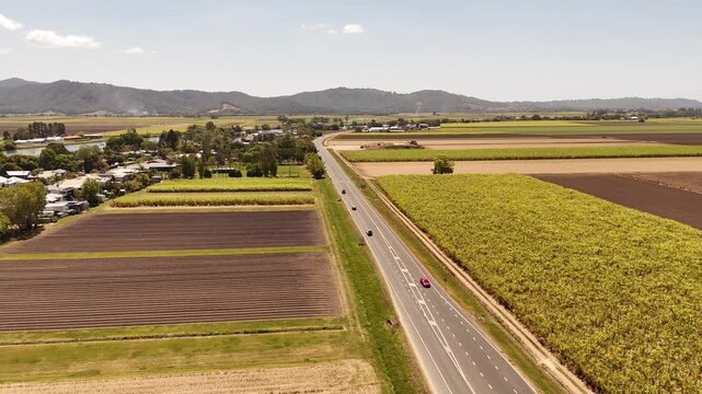 Traffic driving on the Tweed Valley Way near cane fields in northern New South Wales