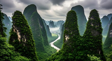 Dramatic karst mountain peaks covered in lush green vegetation with a winding river below under a cloudy sky