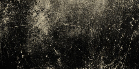 Mysterious dark gray wall texture with industrial concrete tones, artistic grunge detail and warm tone in background.