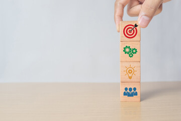 Concept of business strategy and action plan. Hand putting wooden cube block stacking with icon on white background