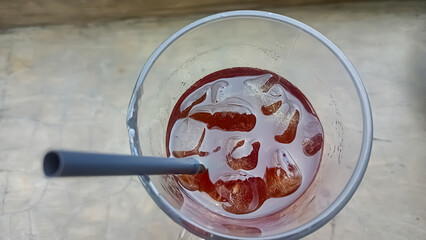 cold drink in a glass with a straw seen from above 
