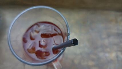 cold drink in a glass with a straw seen from above 