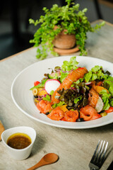 A Fresh and Flavorful Salad with Grilled Fish, Artfully Plated for a Delightful Culinary Experience. Featuring a mix of fresh ingredients with healthy dressing, perfect for food enthusiasts