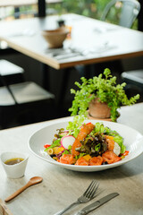 Fresh and vibrant salad with a colorful arrangement, meticulously styled and beautifully presented on a marble table