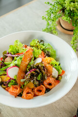 A colorful and healthy salmon salad. This vibrant dish combines the richness of salmon with fresh, crisp vegetables in a satisfying bowl