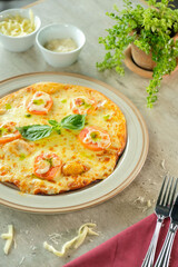 A close-up shot of a delicious pizza, garnished with fresh tomatoes and basil