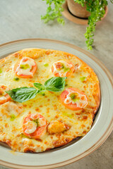 A delicious pizza with fresh ingredients, beautifully presented on a plate. The pizza has tomatoes, basil, and cheese