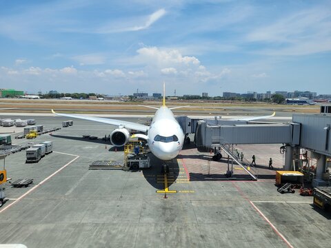 Aerial front view of a Cebu Pacific A330-900neo parked at a gate at Ninoy Aquino International Airport - Manila, Philippines
