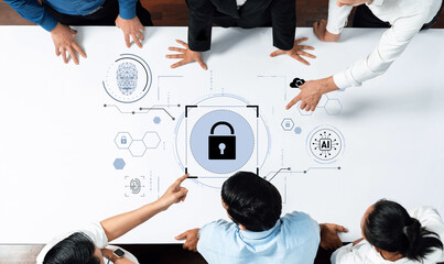 A business team collaborates on cybersecurity strategy, illustrating security concepts with digital graphics that emphasize technology and innovation for effective solutions. Trope