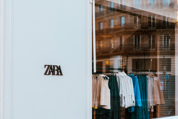 Contemporary Zara facade and calm street reflection, symbol of modern fashion, Paris, France - 5 April 2025