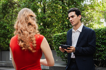 Two professional business people outdoor working together with tablet computer	