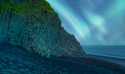 Reynisdrangar rock formations and black beach with aurora borealis - Vik, Iceland