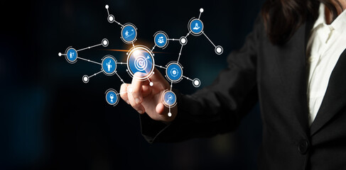 A business professional interacts with a digital network interface, showcasing icons representing...