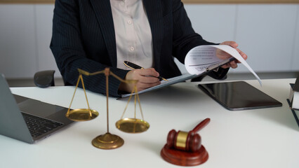 Legal Professional Signing Documents with Scales of Justice