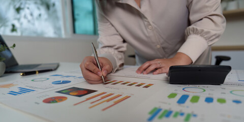 Focused Data Analyst Writing Insights on Financial Reports