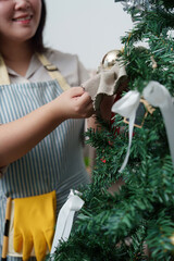 Woman Decorating Christmas Tree with Ornaments