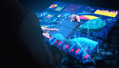 A business professional interacts with a digital interface displaying vibrant graphs and charts, set against a bustling city backdrop at night. Impute