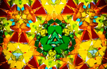Natural kaleidoscope pattern captured with a camera, featuring vibrant stained glass colors and...