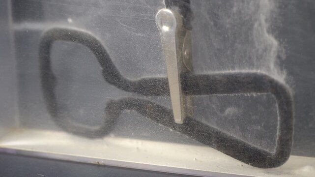 Negative wire leads to cathode and metal part cleaned by electrolysis.