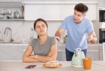 Offended girl brushes aside guy words during argument in kitchen