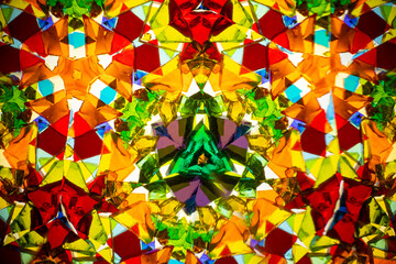 Natural kaleidoscope pattern captured with a camera, featuring vibrant stained glass colors and...