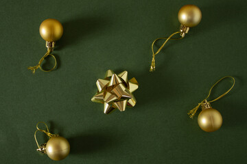Christmas gold decorations balls and bows on a green background