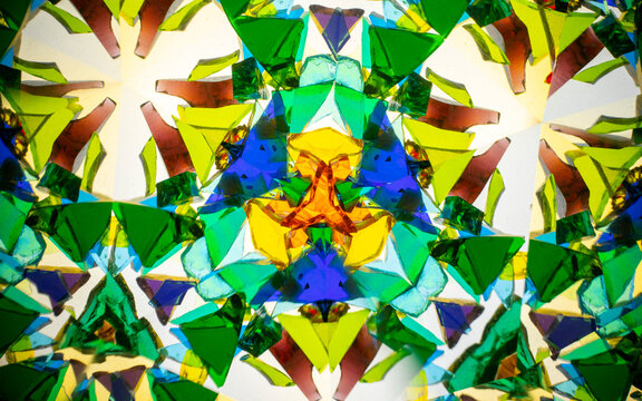 Natural kaleidoscope pattern captured with a camera, featuring vibrant stained glass colors and geometric symmetry. - Powered by Adobe
