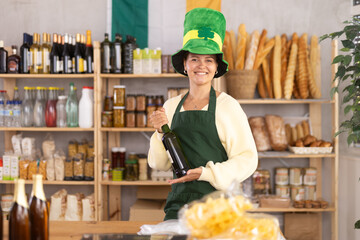 Positive food store female clerk in green hat is preparing to meet customers on eve of St. Patricks...