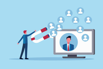 Man uses a large horseshoe magnet to attract people icons from a computer screen representing recruitment and talent acquisition