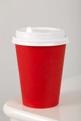 craft cardboard coffee cup with plastic lid, insulated on a white background